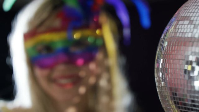  Beautiful girl wearing carnival mask at glamorous party