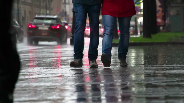 Pedestrians hurry in the rain