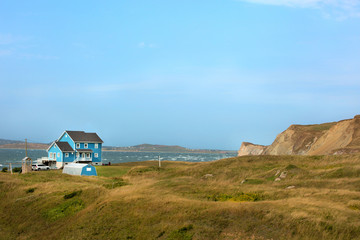 Fototapeta na wymiar Blue house by the sea