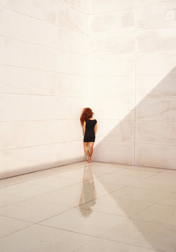 Young woman standing in corner. Concept