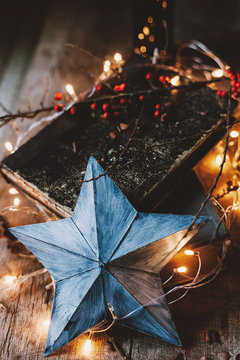 Fototapeta Star ornament with festive lights and books still life