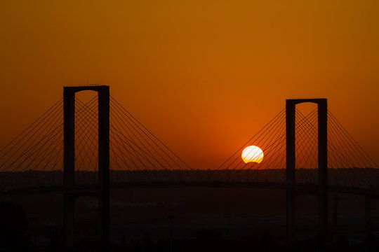 SEVILLE, SPAIN - AUGUST 21, 2017: Fifth Centenary Bridge with partial eclipse sunset