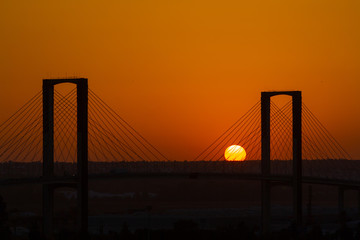 SEVILLE, SPAIN - AUGUST 21, 2017: Fifth Centenary Bridge with partial eclipse sunset