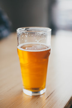 A pint of beer on a table