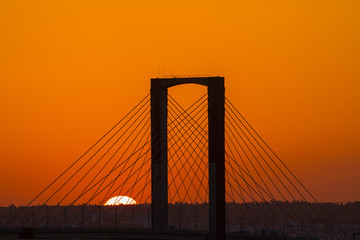 Fototapeta na wymiar SEVILLE, SPAIN - AUGUST 21, 2017: Fifth Centenary Bridge with partial eclipse sunset