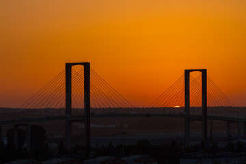 SEVILLE, SPAIN - AUGUST 21, 2017: Fifth Centenary Bridge with partial eclipse sunset