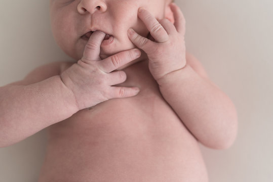 Up Close Image Of Baby Sucking Her Fingers