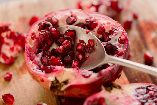 Pomegranate Cut Open with Spoon