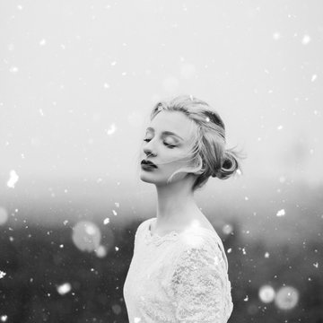 Portrait of a beautiful young woman and a snow