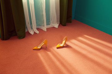 conceptual fashion image with high heels on pink flooring