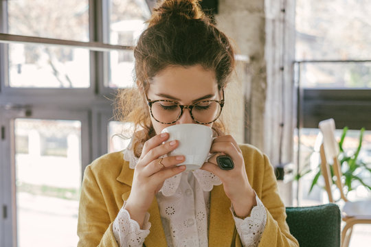 Stylish Young Woman Drinking Coffee