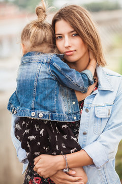 Mother embracing her 3 year old daugher
