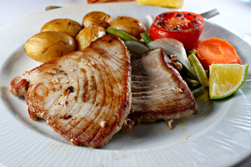 Grilled tuna steak with vegetables, shallow focus
