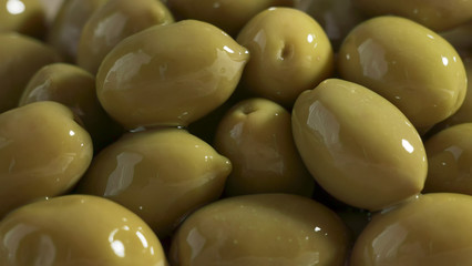 Large shiny green olives macro background