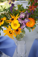 Wildflower Wedding Centerpieces with Black Eyed Susans, Snapdragons, and Delphinium on a Reception Table with White Tablecloth