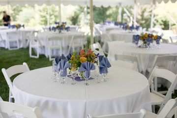Wildflower Wedding Centerpieces with Black Eyed Susans, Snapdragons, and Delphinium on a Reception Table with White Tablecloth
