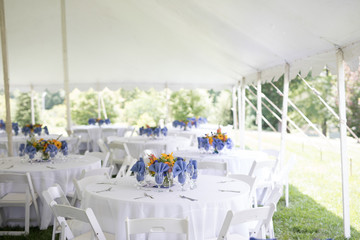 Wildflower Wedding Centerpieces with Black Eyed Susans, Snapdragons, and Delphinium on a Reception Table with White Tablecloth