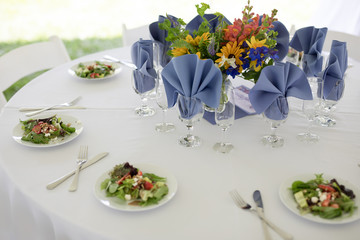 Wildflower Wedding Centerpieces with Black Eyed Susans, Snapdragons, and Delphinium on a Reception Table with White Tablecloth