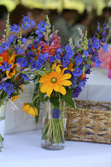 Wildflower Wedding Centerpieces with Black Eyed Susans, Snapdragons, and Delphinium on a Reception Table with White Tablecloth