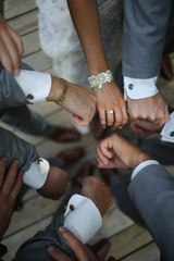 Fototapeta premium Wedding Attire Bride comparing her Bracelet to the Groom and Groomsmen Cuff links 