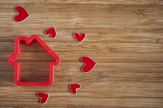 men figure with a house on wooden background