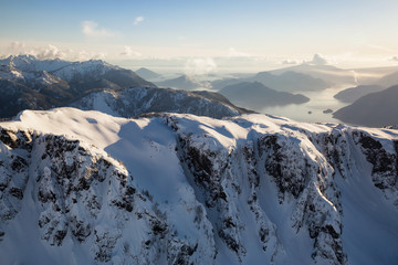 Aerial mountain landscape view covered in snow. Picture taken near Howe Sound, South of Squamish, BC, Canada.