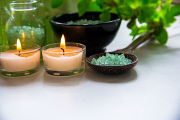 Thai Spa Treatments aroma therapy  salt and nature green sugar scrub and rock massage with green orchid flower on wooden white with candle. Thailand.  Healthy Concept. copy space,select and soft focus