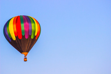 Multi Colored Hot Air Balloon Above Tree Line