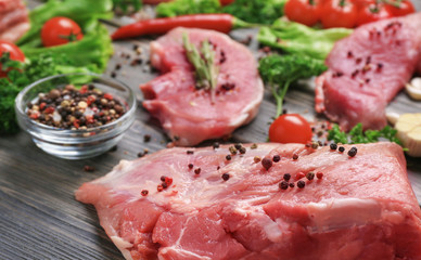 Different types of meat on wooden table