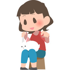 膝の上にうさぎを乗せる女性
