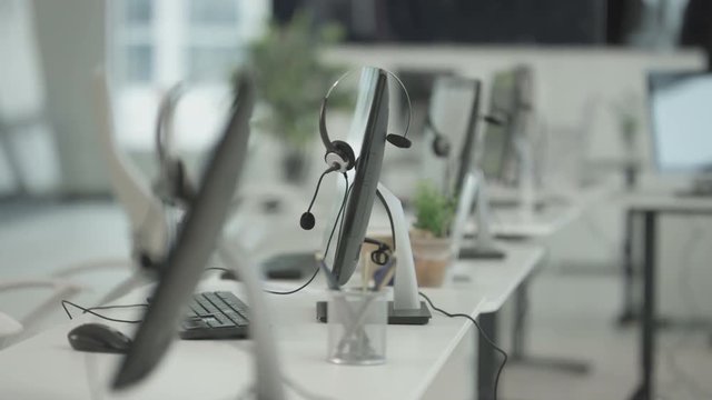  Workstations in a telesales office, headsets on computer monitors