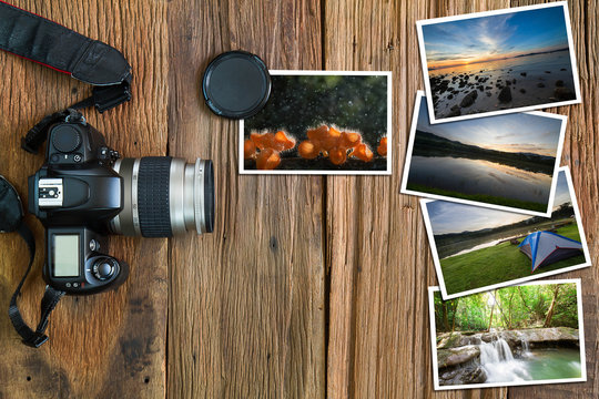 Old camera and stack of photos on vintage grunge wooden background, photography hobby lifestyle concept