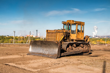 Obraz na płótnie Canvas Yellow bulldozer on the construction site