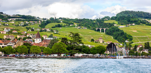 Beautiful Summer landscape of Lake Geneva, Lavaux vineyard terraces and Alps, Lutry village, Switzerland, Europe.