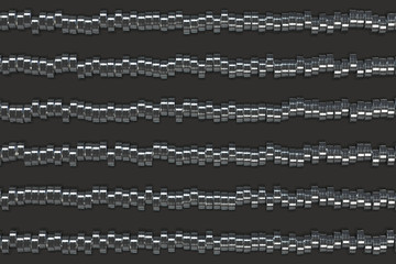 Pattern of brushed metal cylinder tablets on black background