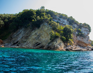  turquoise green transparent water on a background of bright limestone rocks in a bright summer day