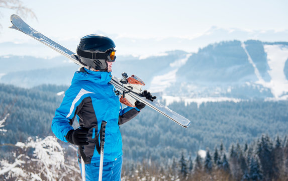 Young female skier with skiing equipment enjoying at winter ski resort in beautiful sunny day copyspace happiness positivity vacation travelling Bukovel