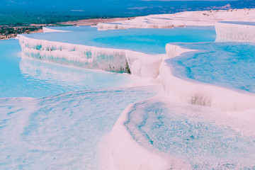 Turquoise color view of Pamukkale (Cotton Castle) is popular with Travertine pools and terraces  where people love to visit in Pamukkale, Turkey.