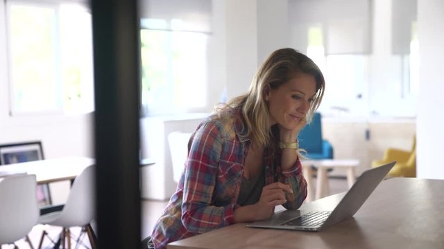 Mature couple connected with laptop at home