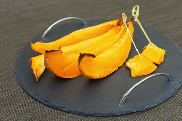 Slices of sweet pumpkin baked with sugar syrup in the oven. Pumpkin dessert.