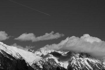 Cloud covered mountain peak in Austrian alps landscape, black and white