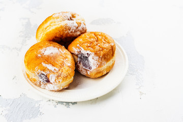Tasty homemade donuts with jam on white background. Copy space