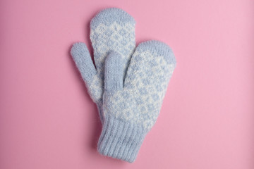 Blue mitten on pink background