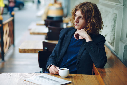 Portrait interesting reddish man posing with coffee