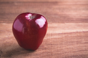 Ripe of red apples on wooden background