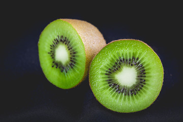 Ripe whole kiwi fruit and half kiwi fruit