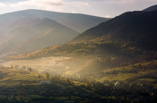 foggy autumn sunrise in mountainous rural area