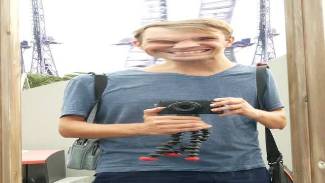 a man takes his reflection in a false mirror on the camera. lifestyle journey. 4k