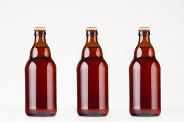 Set of brown steinie belgian beer bottles  330ml mock up. Template for advertising, design, branding identity on white wood table.