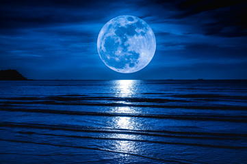 Naklejka na ściany i meble Super moon. Colorful sky with cloud and bright full moon over seascape.